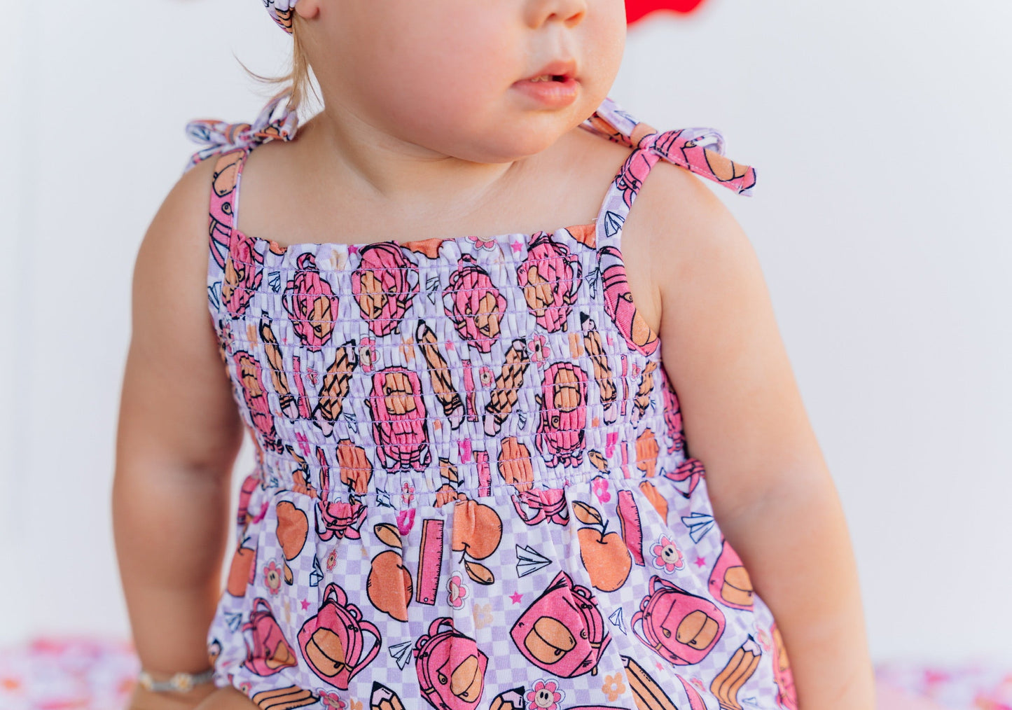 RULE THE SCHOOL SMOCKED BUBBLE ROMPER